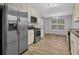 Open concept kitchen with stainless steel appliances and eat in area at 3946 Village Crossing Ln, Ellenwood, GA 30294
