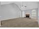 Living room with vaulted ceiling, fireplace, and neutral carpet at 3946 Village Crossing Ln, Ellenwood, GA 30294
