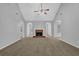 Expansive living room showcases vaulted ceilings, large brick fireplace, and neutral finishes at 3946 Village Crossing Ln, Ellenwood, GA 30294