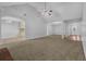 Bright open-concept living room leading into a kitchen with neutral walls and flooring at 3946 Village Crossing Ln, Ellenwood, GA 30294