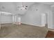 Spacious living area with vaulted ceiling, plush carpeting and entry to the foyer at 3946 Village Crossing Ln, Ellenwood, GA 30294