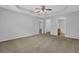 Spacious primary bedroom boasts tray ceilings, neutral palette, and multiple doorways at 3946 Village Crossing Ln, Ellenwood, GA 30294