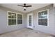 Screened porch with ceiling fan and natural light pouring through the windows at 3946 Village Crossing Ln, Ellenwood, GA 30294