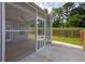 Relaxing screened porch with ceiling fan overlooking the backyard and wood fence at 3946 Village Crossing Ln, Ellenwood, GA 30294