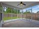 Relaxing screened porch with ceiling fan overlooking the backyard and wood fence at 3946 Village Crossing Ln, Ellenwood, GA 30294