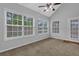 Bright sunroom features many windows and a glass door, offering ample natural light at 3946 Village Crossing Ln, Ellenwood, GA 30294