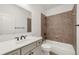 Bathroom with a tiled shower and tub combo, neutral walls, and vanity with a white countertop at 4435 Manor Creek Dr, Cumming, GA 30040
