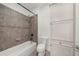Bathroom with tile surround, shower, toilet, and built-in white linen closet for storage at 4435 Manor Creek Dr, Cumming, GA 30040