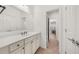 Bathroom with a white vanity and countertop sink, a large mirror, and neutral colored walls at 4435 Manor Creek Dr, Cumming, GA 30040