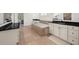 Bathroom features a soaking tub with tile surround, white cabinets with black countertops, and tile floors at 4435 Manor Creek Dr, Cumming, GA 30040