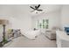 Bright bedroom featuring a large window, ceiling fan, books and plenty of space for furniture at 4435 Manor Creek Dr, Cumming, GA 30040