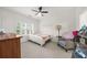 Bright bedroom with ceiling fan, shuttered windows, and a cozy reading corner at 4435 Manor Creek Dr, Cumming, GA 30040