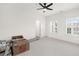 Spacious bedroom with plenty of natural light from the windows and ceiling fan for added comfort at 4435 Manor Creek Dr, Cumming, GA 30040