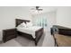 Bedroom featuring hardwood floors, a ceiling fan, and large bed with dark wood furniture at 4435 Manor Creek Dr, Cumming, GA 30040