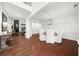 Elegant dining area featuring hardwood floors, a modern chandelier, and wainscoting detail at 4435 Manor Creek Dr, Cumming, GA 30040