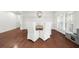 Bright dining area featuring hardwood floors, plantation shutters, and a rustic wood table at 4435 Manor Creek Dr, Cumming, GA 30040