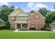 Stunning two-story brick home with a meticulously manicured lawn and inviting curb appeal at 4435 Manor Creek Dr, Cumming, GA 30040