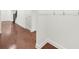 Hallway with hardwood floors, white trim, and a view of the stairs and a side entrance at 4435 Manor Creek Dr, Cumming, GA 30040