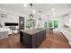 Spacious kitchen with island, stainless steel appliances, hardwood floors, and an open floorplan at 4435 Manor Creek Dr, Cumming, GA 30040
