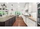 Modern kitchen with granite countertops, stainless steel appliances, and a view to the backyard at 4435 Manor Creek Dr, Cumming, GA 30040