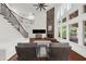 Bright living room featuring a stone fireplace, hardwood floors, and staircase at 4435 Manor Creek Dr, Cumming, GA 30040