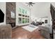 Spacious living room featuring a stone fireplace, hardwood floors, and an open layout at 4435 Manor Creek Dr, Cumming, GA 30040