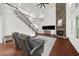 Bright living room with stone fireplace, high ceilings, wood floors, and large windows at 4435 Manor Creek Dr, Cumming, GA 30040