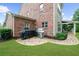 Brick patio with grill station and covered outdoor seating area, perfect for entertaining and relaxation at 4435 Manor Creek Dr, Cumming, GA 30040