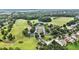 Aerial view of golf course, clubhouse, and surrounding residences showcasing the community's layout at 6861 Louis Dr, Locust Grove, GA 30248