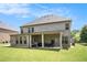 Brick home with a covered patio, perfect for relaxing and outdoor entertaining at 6861 Louis Dr, Locust Grove, GA 30248