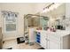 Bright bathroom featuring a glass shower, modern vanity, and ample storage at 6861 Louis Dr, Locust Grove, GA 30248