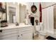 Eclectic bathroom featuring stylish decor, vanity with sink, and tiled shower at 6861 Louis Dr, Locust Grove, GA 30248