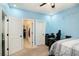 Blue bedroom offers a ceiling fan, dark furnishings and a personal touch at 6861 Louis Dr, Locust Grove, GA 30248