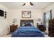 Comfortable bedroom featuring a ceiling fan and furnishings at 6861 Louis Dr, Locust Grove, GA 30248