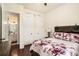 Inviting bedroom with rustic headboard, floral comforter, and stylish decor at 6861 Louis Dr, Locust Grove, GA 30248