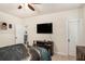 Comfortable bedroom with a TV, ceiling fan, and ensuite access at 6861 Louis Dr, Locust Grove, GA 30248