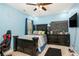 Blue bedroom offers a ceiling fan, dark furnishings and a personal touch at 6861 Louis Dr, Locust Grove, GA 30248