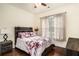 Comfortable bedroom with floral bedding, wooden headboard, and ample natural light at 6861 Louis Dr, Locust Grove, GA 30248