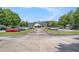 View of clubhouse situated at the end of tree-lined driveway and expansive parking lot at 6861 Louis Dr, Locust Grove, GA 30248