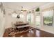 Bright dining room featuring hardwood floors, modern table, and large windows at 6861 Louis Dr, Locust Grove, GA 30248