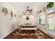 Cozy dining room with a modern farmhouse table, comfortable seating, and natural light at 6861 Louis Dr, Locust Grove, GA 30248