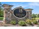 Stone-crafted entrance sign adorned with flowers and lush greenery, marking the entrance at 6861 Louis Dr, Locust Grove, GA 30248