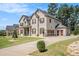 A spacious two-story home features a three-car garage and a long driveway, offering ample parking at 6861 Louis Dr, Locust Grove, GA 30248