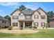 Stunning two-story brick home with a well-manicured lawn and lovely landscaping in a desirable neighborhood at 6861 Louis Dr, Locust Grove, GA 30248