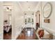 Inviting foyer features gleaming hardwood floors, elegant wainscoting, and a welcoming bench at 6861 Louis Dr, Locust Grove, GA 30248