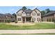 Beautiful home featuring meticulously maintained lawn, bushes, and flowerbeds for great curb appeal at 6861 Louis Dr, Locust Grove, GA 30248