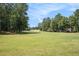 Expansive golf course with lush green fairways and mature trees creating a serene landscape at 6861 Louis Dr, Locust Grove, GA 30248