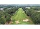 Aerial view showcasing the lush green golf course with manicured fairways and mature trees at 6861 Louis Dr, Locust Grove, GA 30248
