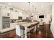 Open kitchen with granite countertops, pendant lighting, white cabinets, and stainless steel appliances at 6861 Louis Dr, Locust Grove, GA 30248
