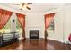 Bright sitting area featuring a fireplace, hardwood floors, neutral paint and two large windows at 6861 Louis Dr, Locust Grove, GA 30248